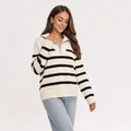 Female model wearing a cream quarter-zip sweater with black horizontal stripes, paired with light blue jeans.