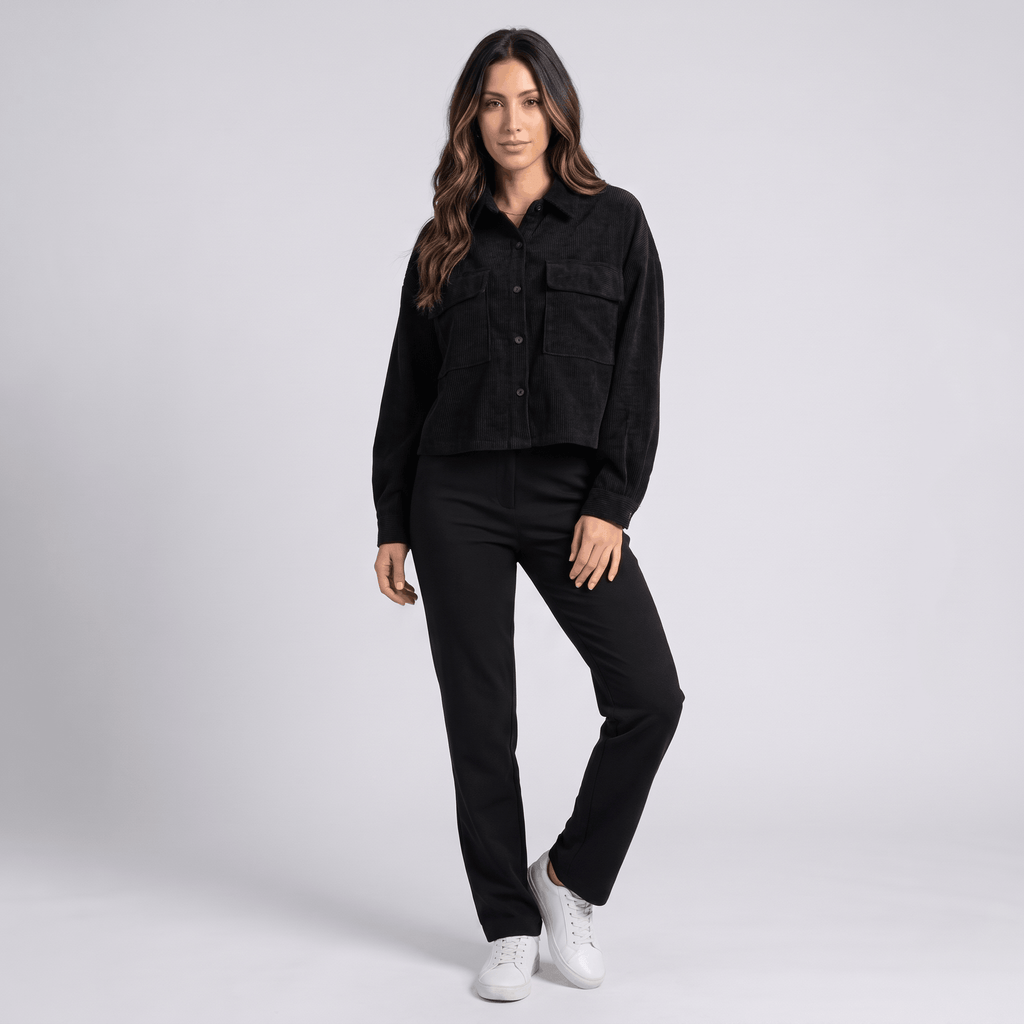 Muted brown corduroy overshirt with drop shoulders and chest pockets, worn buttoned over matching trousers and sneakers.