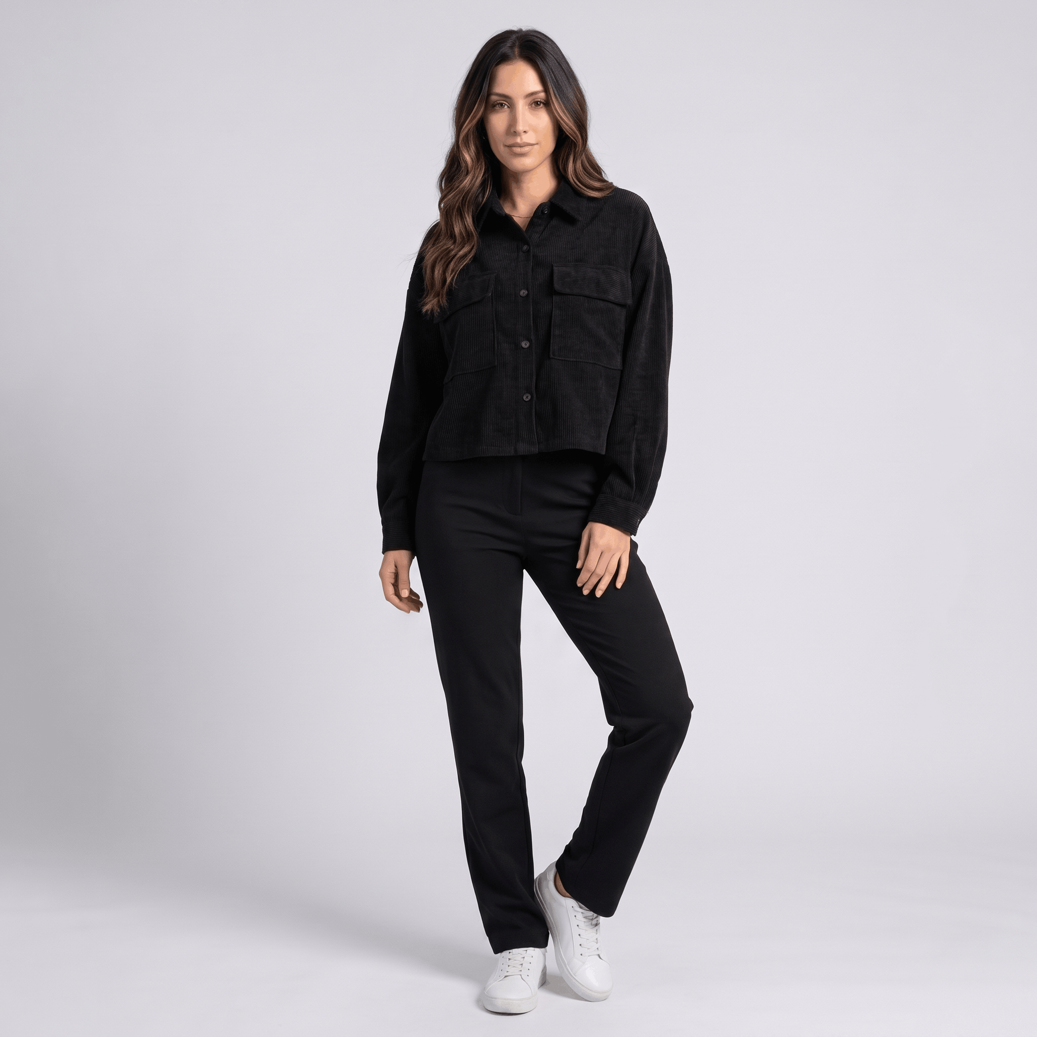 Muted brown corduroy overshirt with drop shoulders and chest pockets, worn buttoned over matching trousers and sneakers.