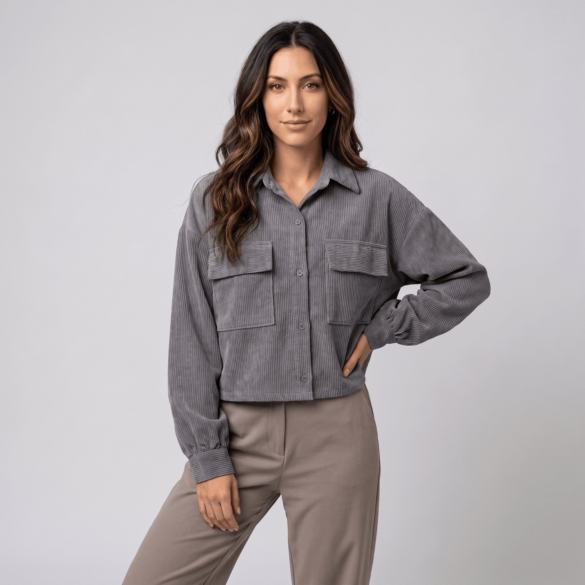Grey corduroy overshirt with a relaxed drop-shoulder fit, button-front closure, and dual chest pockets.