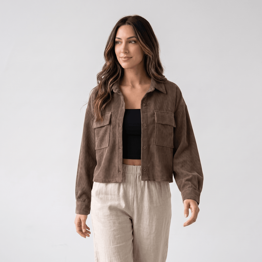 Muted brown corduroy overshirt with a relaxed drop-shoulder fit, button-front closure, and dual chest pockets.
