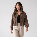 Muted brown corduroy overshirt with a relaxed drop-shoulder fit, button-front closure, and dual chest pockets.