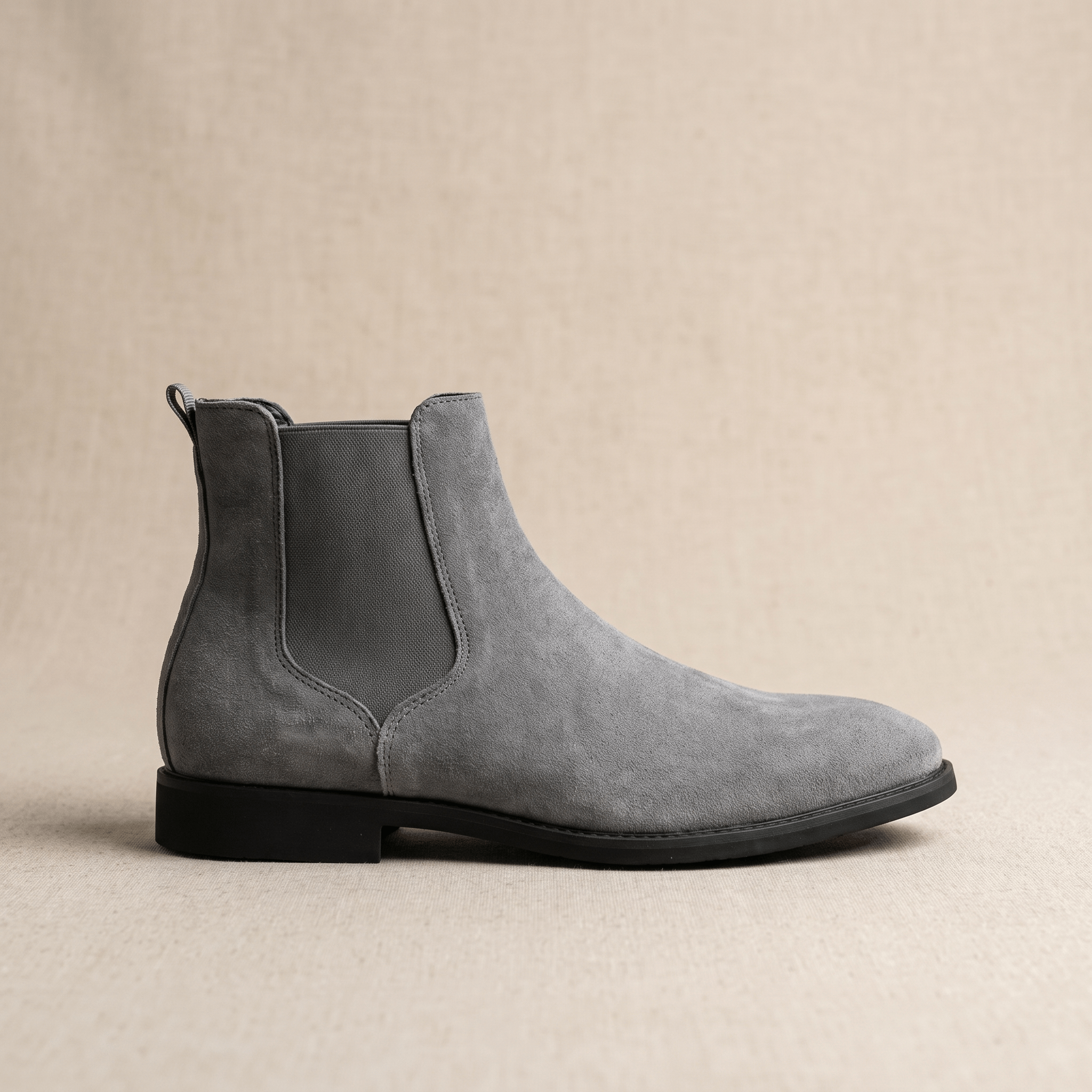 Single gray Chelsea boot showing the elastic side panel, pull tab, and sleek low-profile sole.