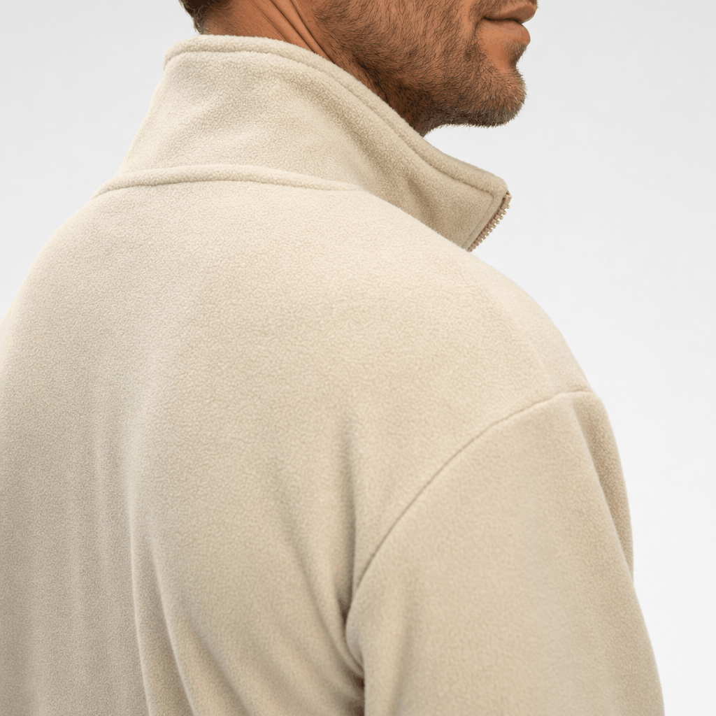Close-up back and side view of a cream zip-up jacket, highlighting the raised stand collar and shoulder.