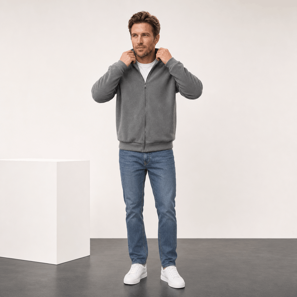 Male model wearing the gray zip-up jacket while adjusting the collar.