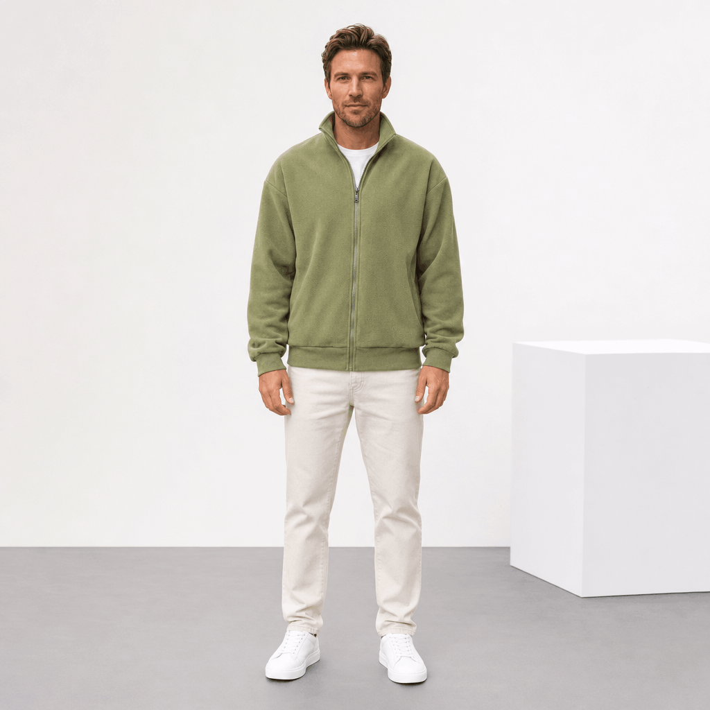 Male model wearing the olive green zip-up jacket with light-colored pants.