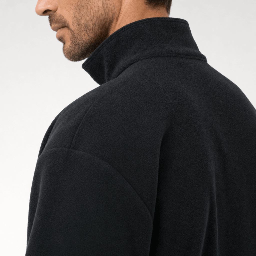 Close-up back and side view of the black jacket, highlighting the raised collar and shoulder.