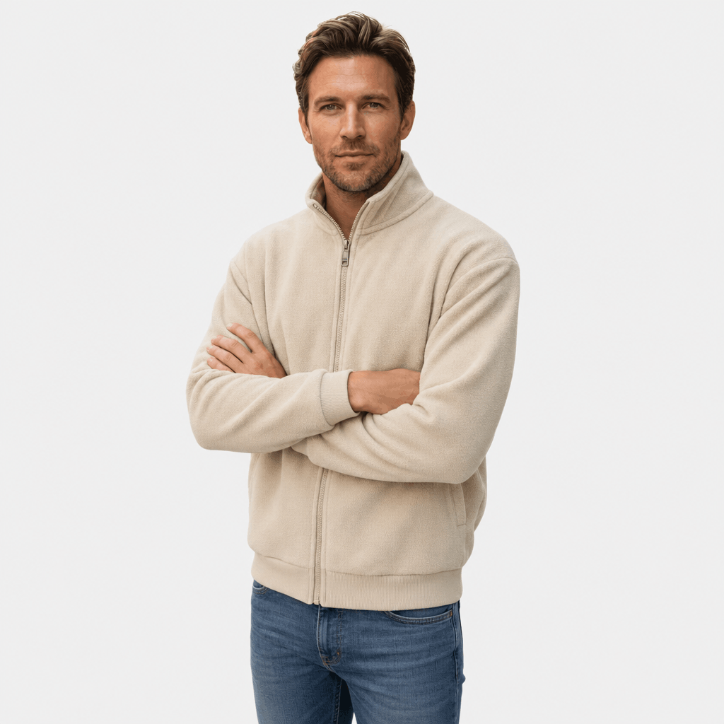 Male model wearing a light beige zip-up jacket with a stand collar and arms crossed.