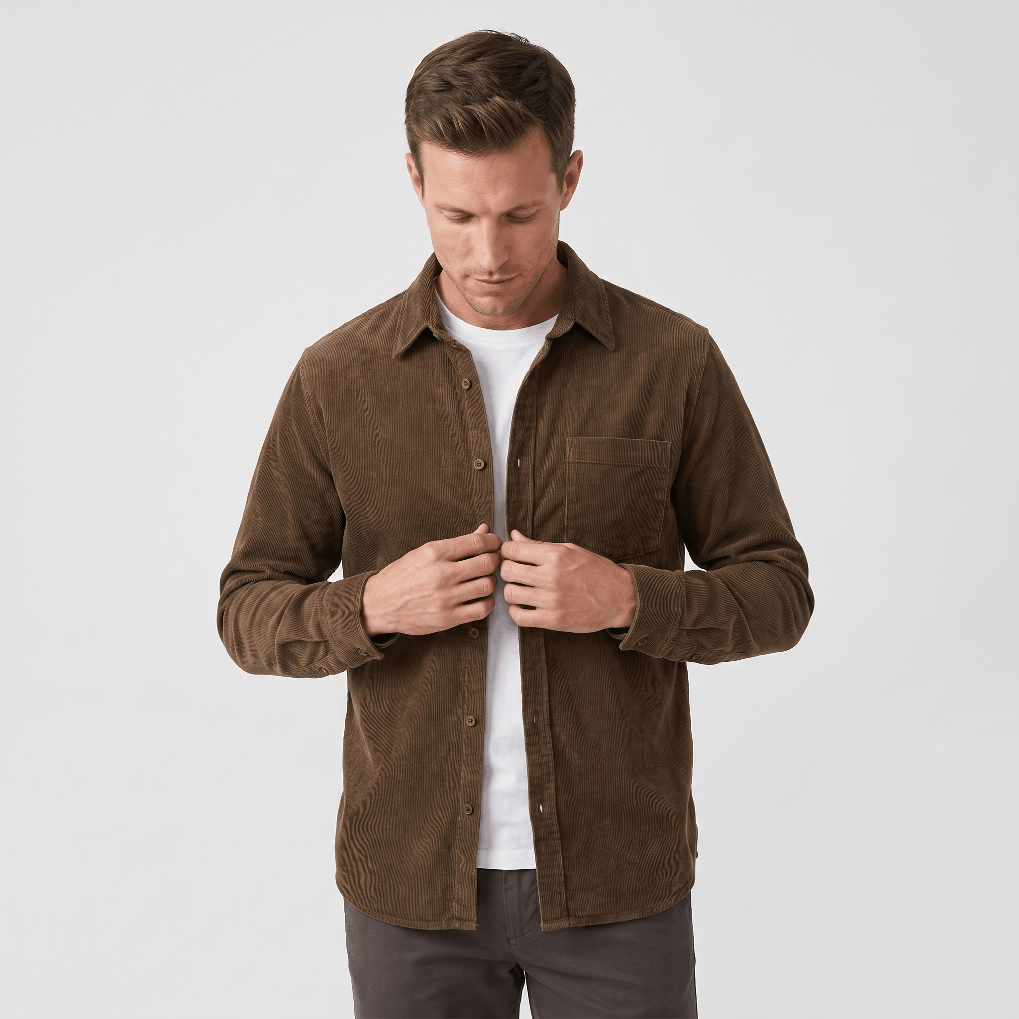 Brown washed corduroy button-up shirt in a regular fit with a single chest pocket, worn open over a white t-shirt.