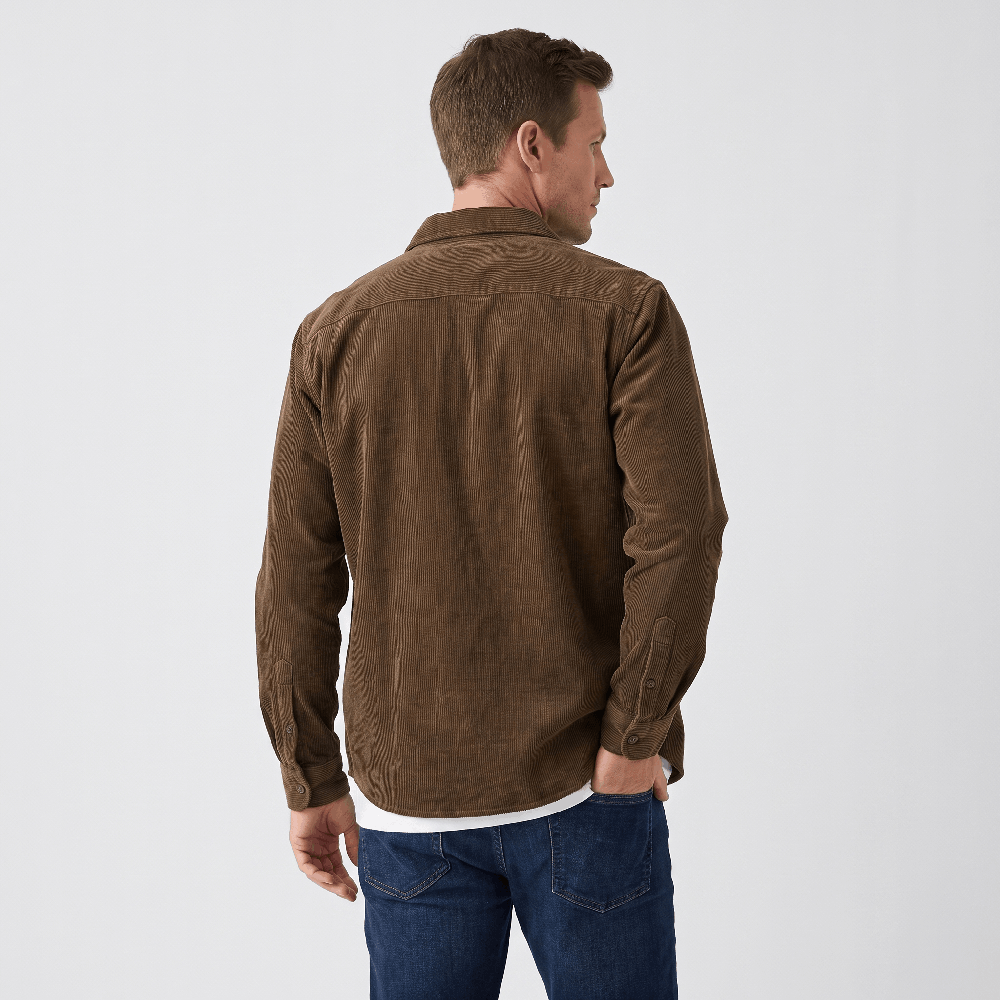 Brown washed corduroy button-up shirt in a regular fit, worn over a white tee with blue denim jeans.