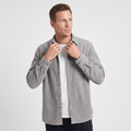 Grey washed corduroy button-up shirt in a regular fit, worn open over a white t-shirt with a single chest pocket.