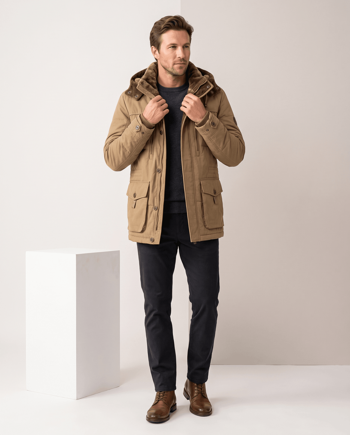 A man wearing a camel fleece-lined parka with an insulated hood, zip front, and weather-resistant outer shell
