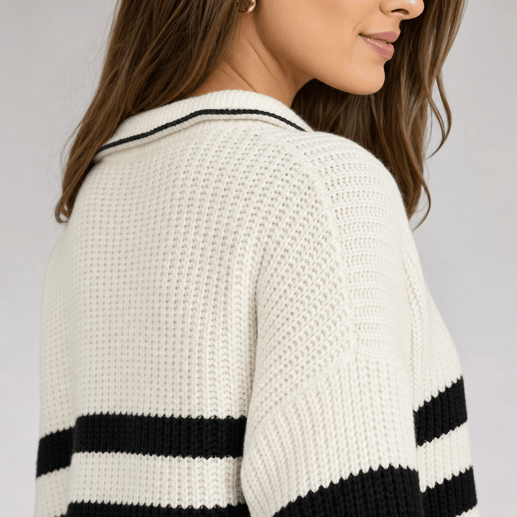 Back view of the white and black striped quarter-zip sweater, showing the knit texture, raised collar, and stripe detail on the sleeves.