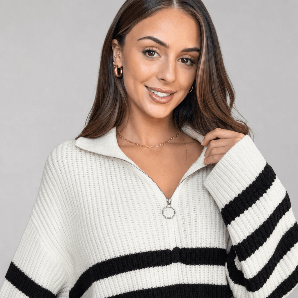 Close-up of the female model wearing the white striped quarter-zip sweater, highlighting the zipper collar and black stripe pattern.