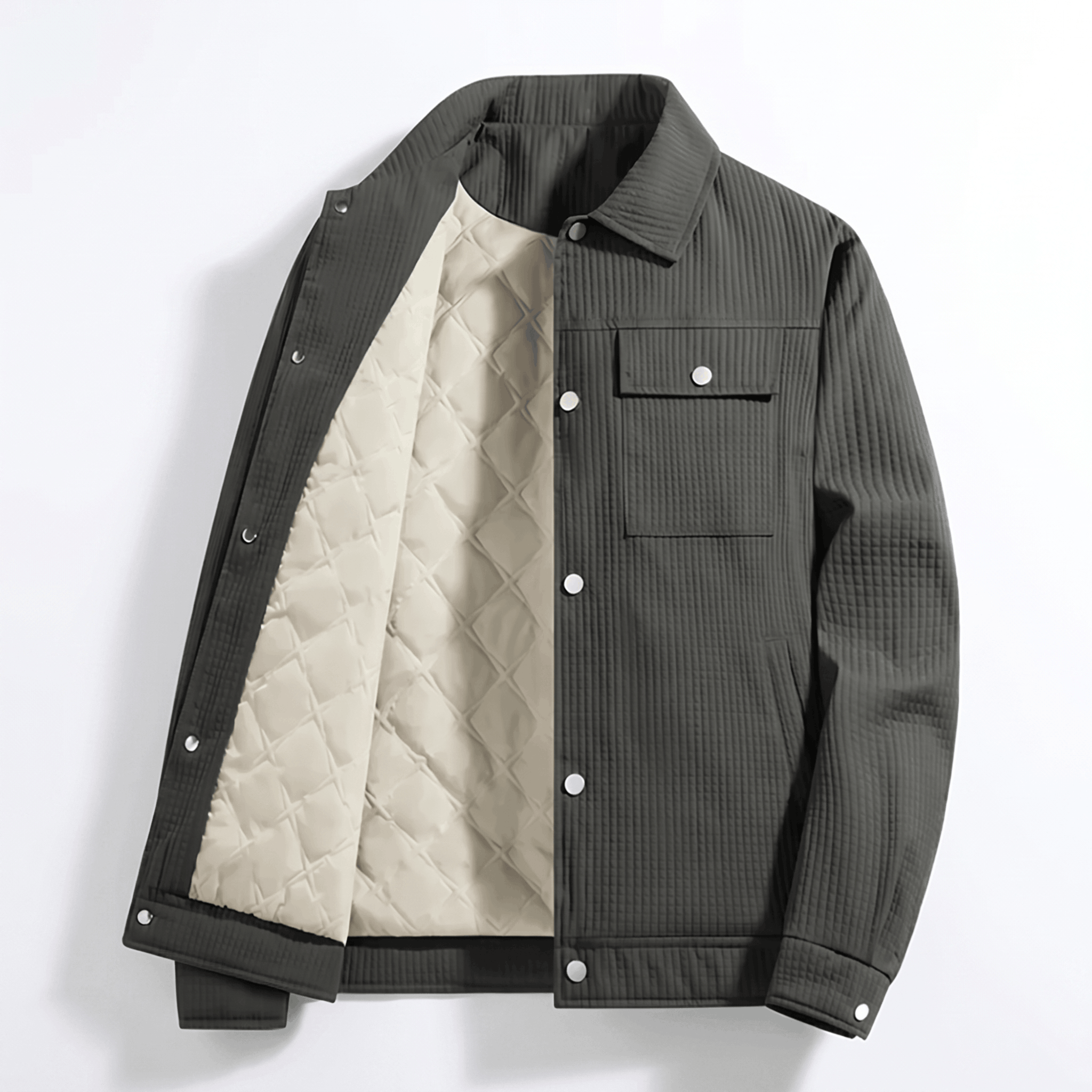 Dark grey corduroy trucker jacket with a cream diamond-quilted lining, snap-button front, and dual chest flap pockets.