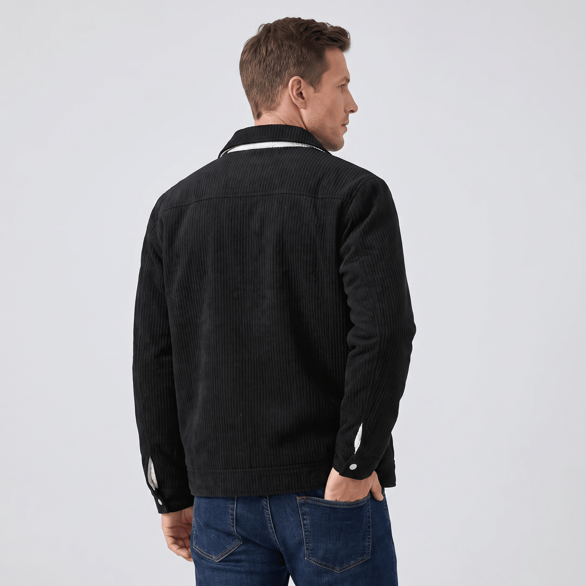 Black corduroy trucker jacket with a structured fit, featuring snap-button cuffs and a clean, textured silhouette.