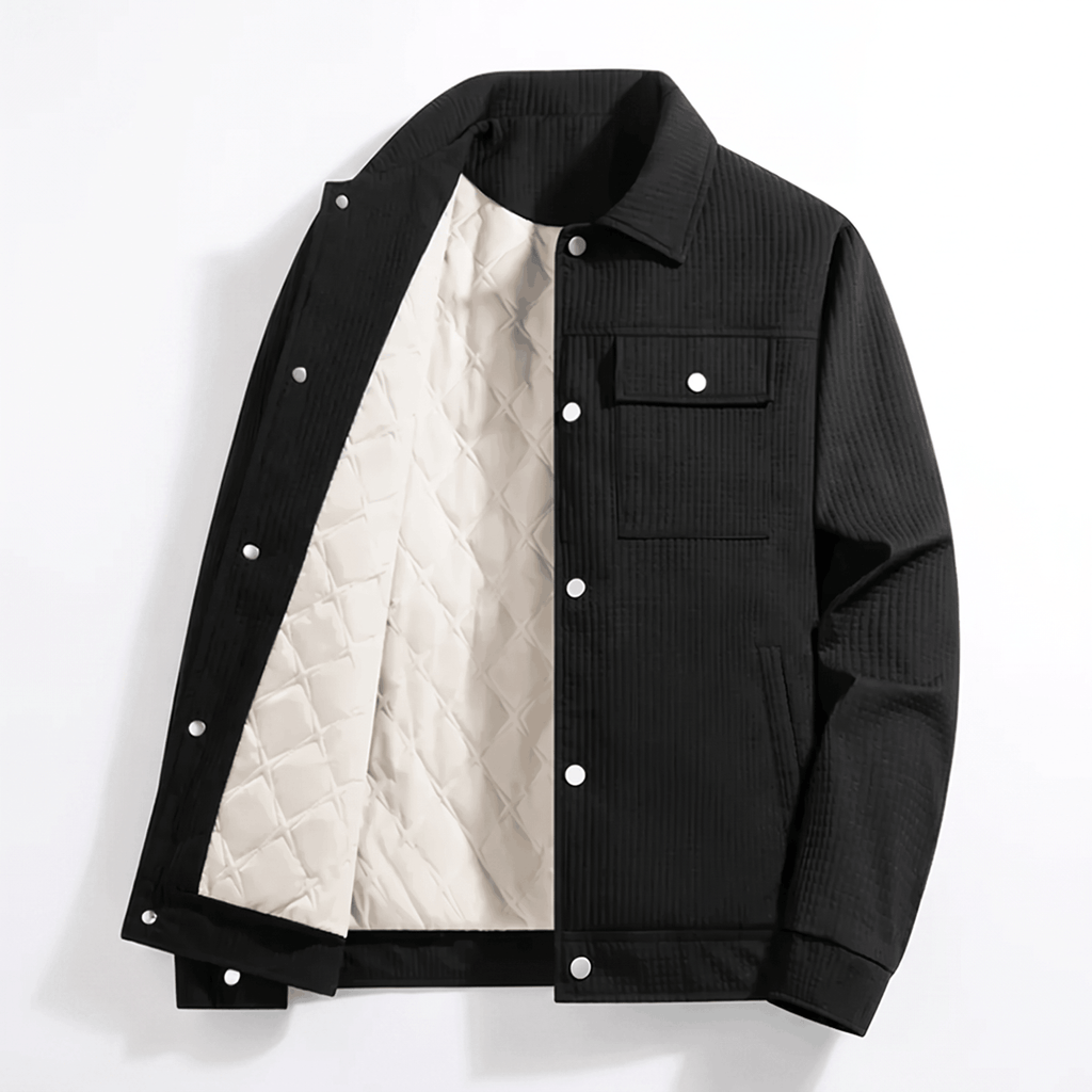 Black corduroy trucker jacket with a white diamond-quilted lining, snap-button front, and flap chest pockets.