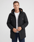 A man wearing a black insulated winter parka with a hood, full-zip front, and multiple utility pockets