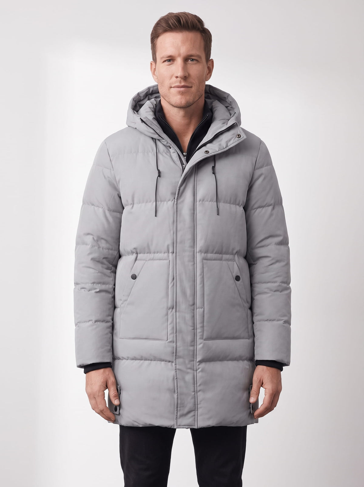 Light gray hooded quilted winter coat with longline design and front pockets worn by a male model