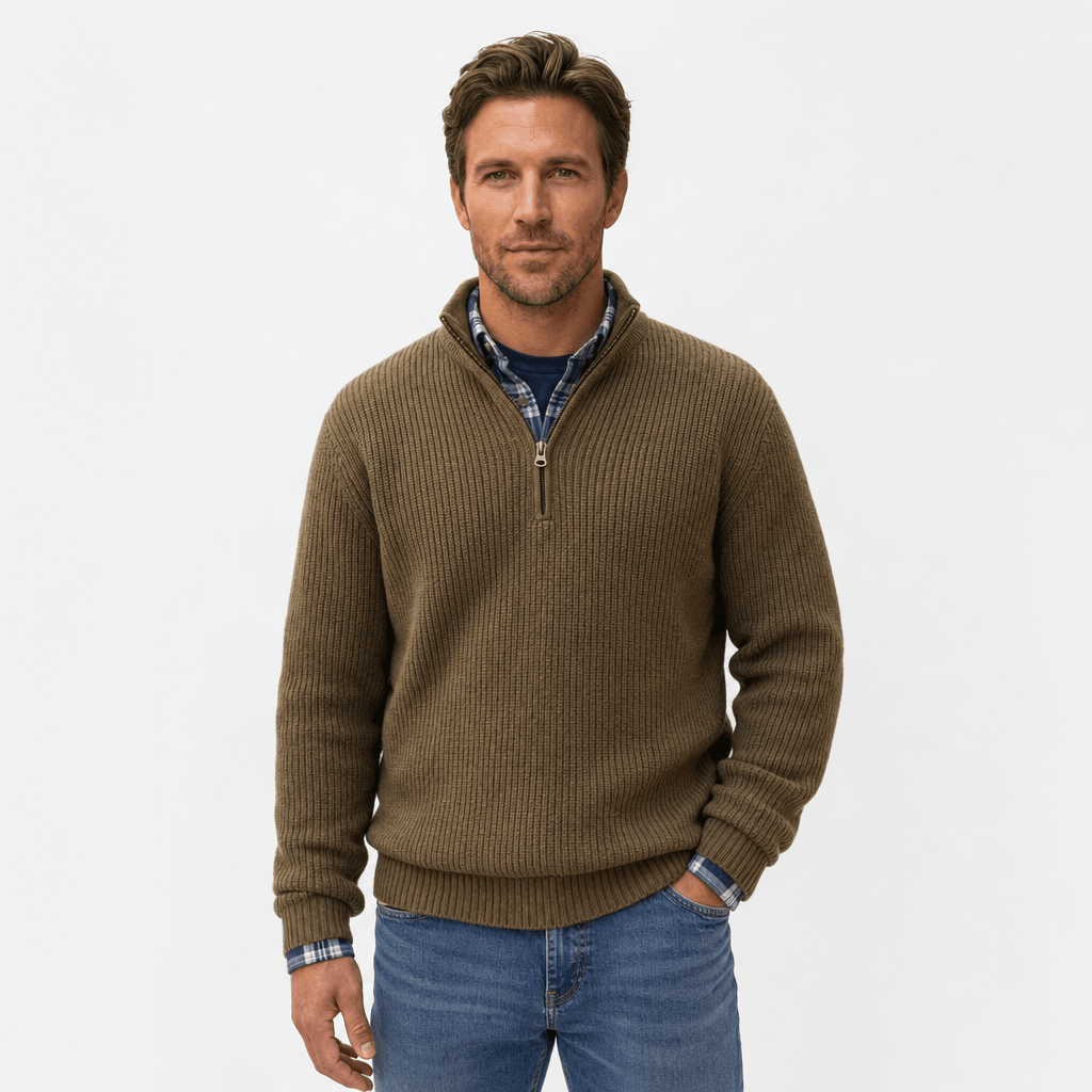 Man wearing a brown ribbed knit quarter-zip sweater over a blue shirt and blue jeans.