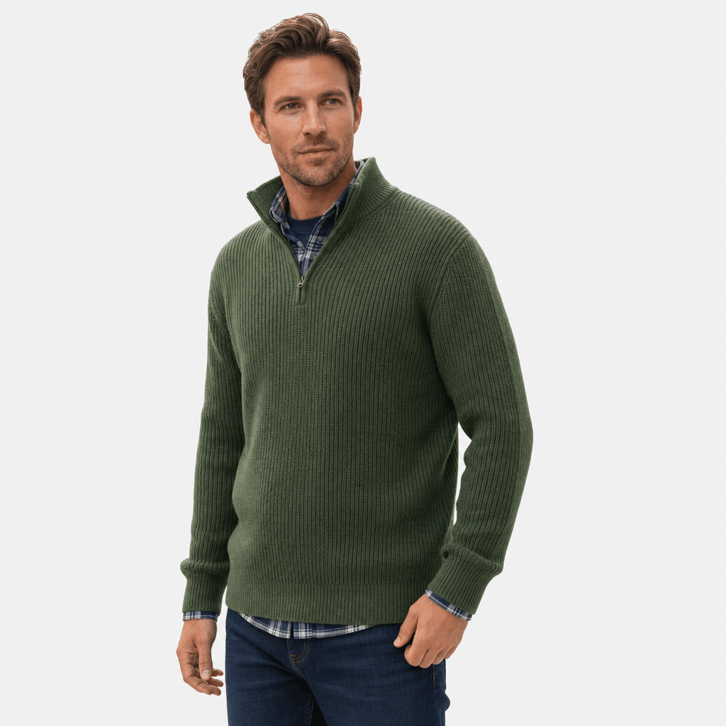 Man wearing a dark green ribbed knit quarter-zip sweater over a blue shirt.
