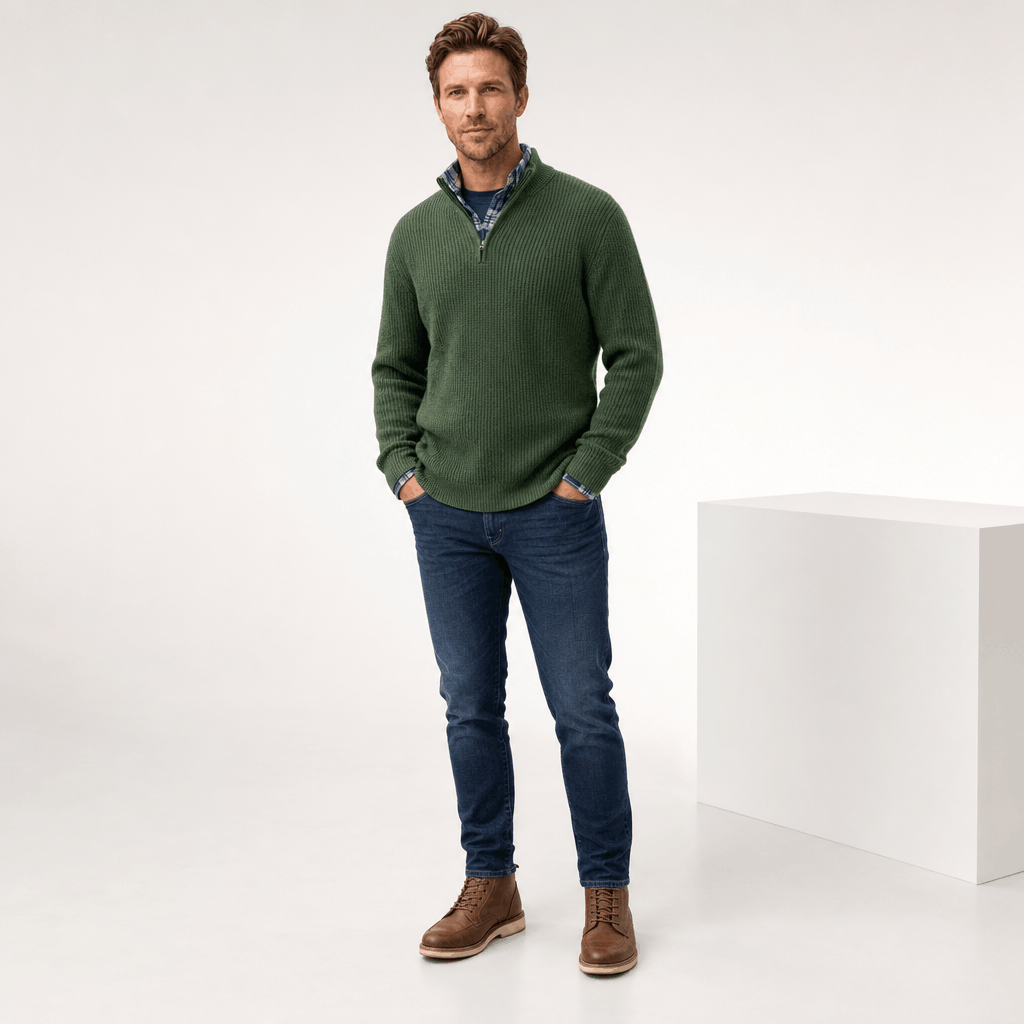 Man wearing the dark green quarter-zip sweater with dark trousers.
