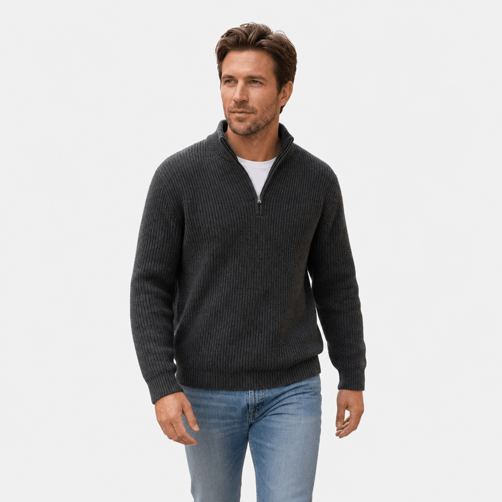 Man wearing the dark green quarter-zip sweater with dark trousers.