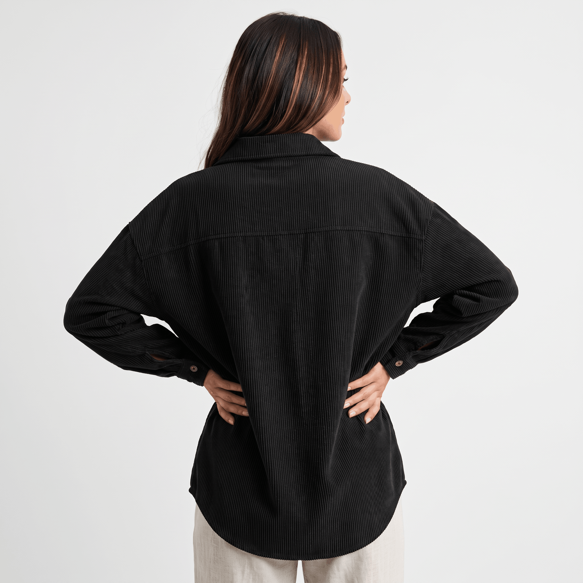 Black corduroy button-down shirt with a relaxed, oversized fit, drop shoulders, and a classic point collar.