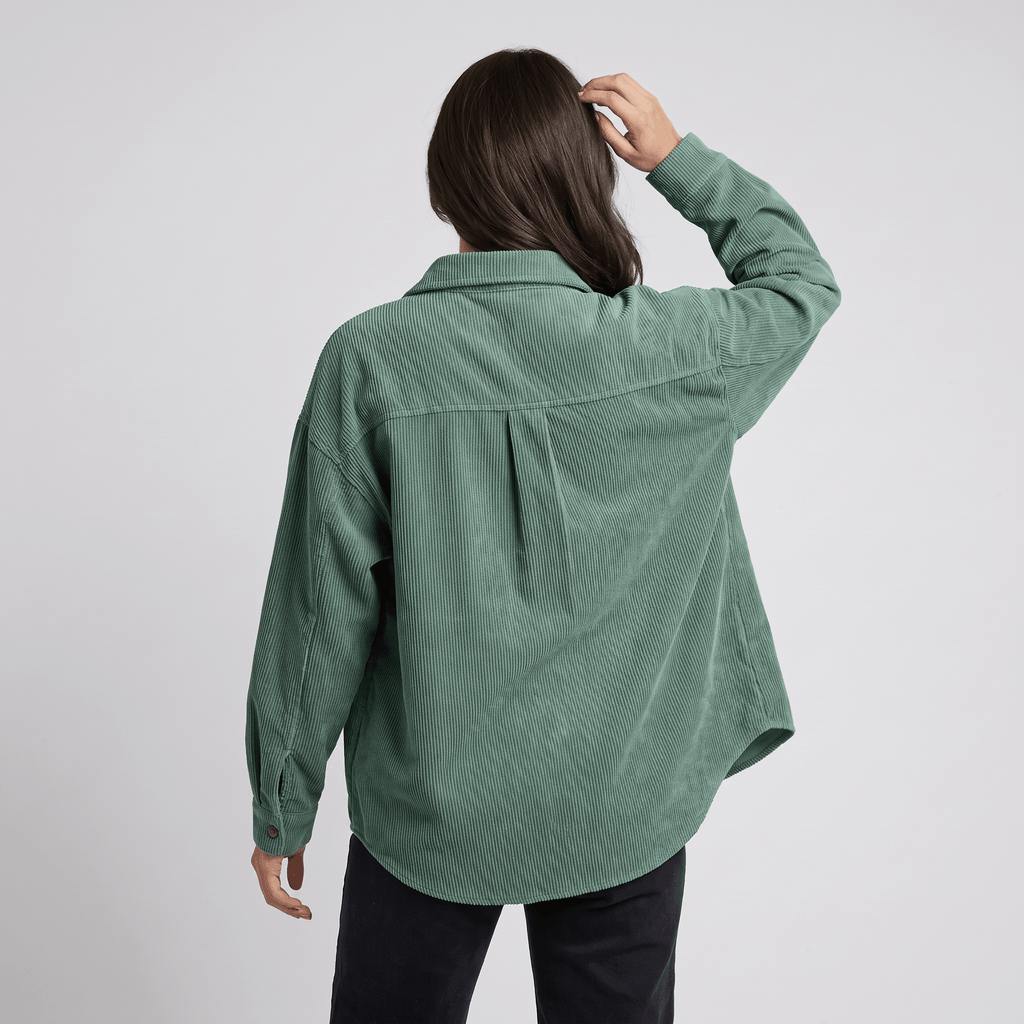 Sage green corduroy button-down shirt with a relaxed, oversized fit, drop shoulders, and a classic point collar.