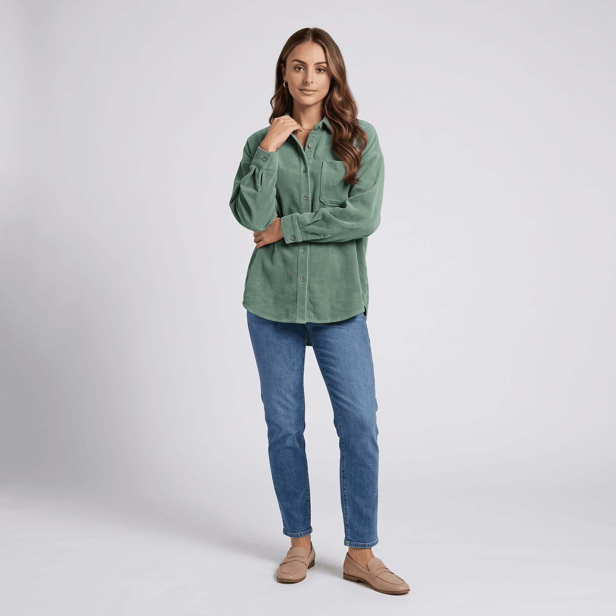 Sage green corduroy button-down shirt with a relaxed, oversized fit, drop shoulders, and point collar worn with jeans.
