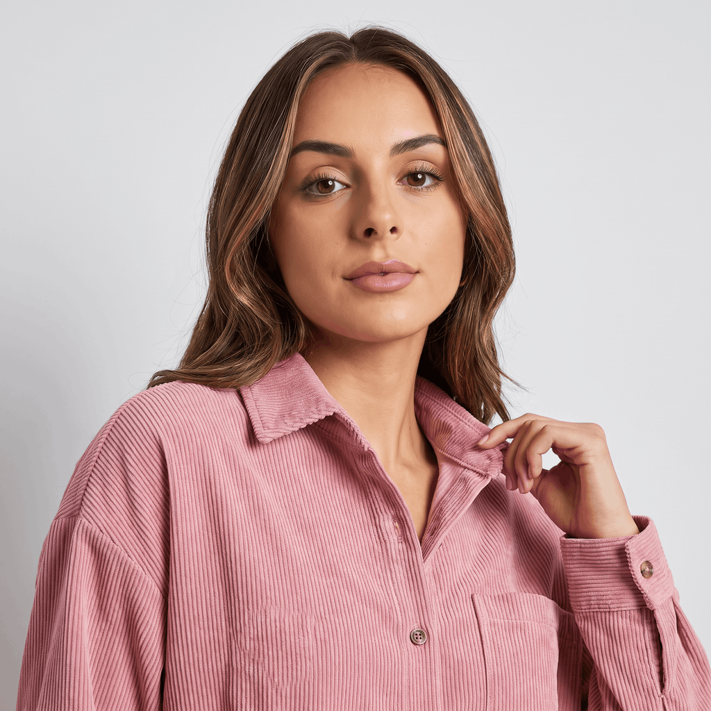 Oversized rust-toned corduroy button-down shirt with a point collar, drop shoulders, and fine ribbed texture.