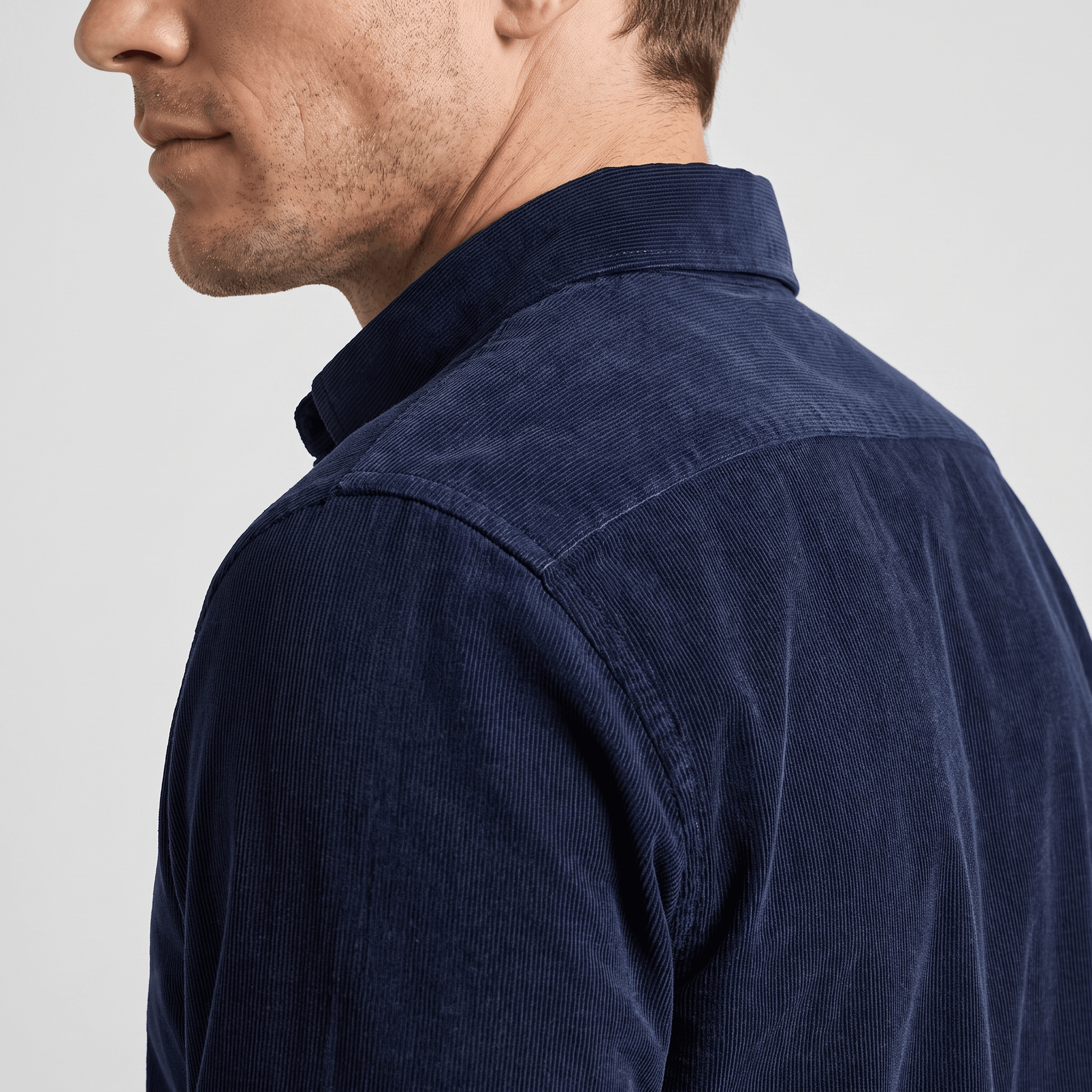 Navy blue slim-fit corduroy shirt with a classic collar and clean, pocketless front design.