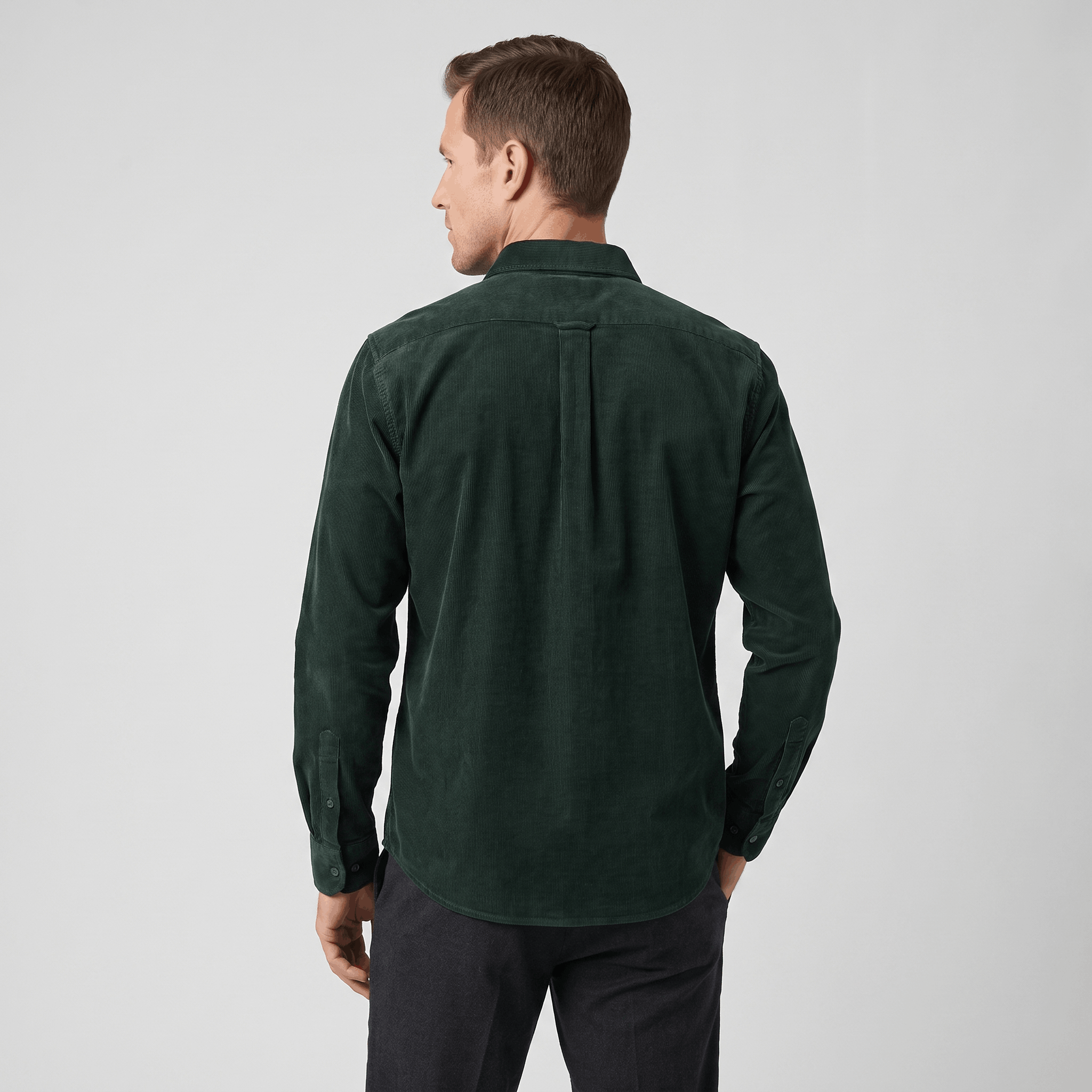 Dark green slim-fit corduroy shirt with a tailored back yoke and long sleeves, worn with dark trousers.