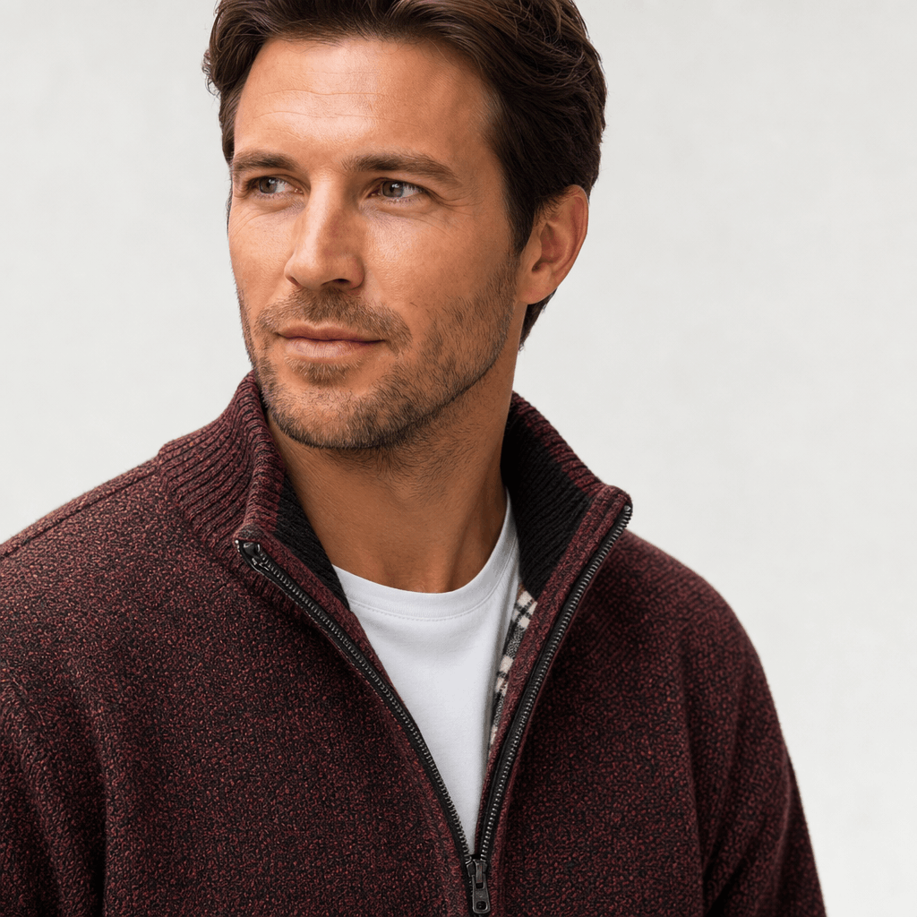 Detailed view of the burgundy jacket, highlighting the textured fabric, stand collar, and zipper.