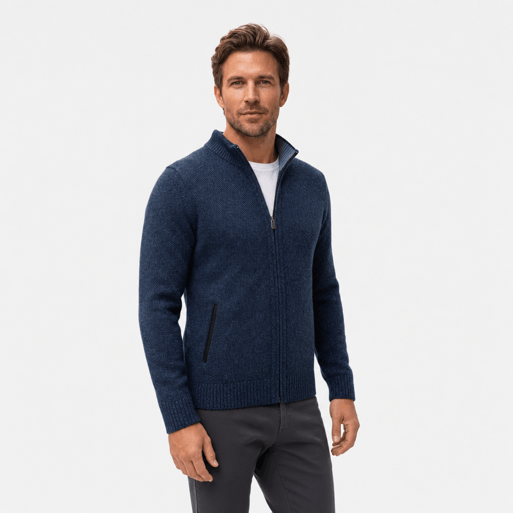 Male model wearing a navy blue textured zip-up jacket.