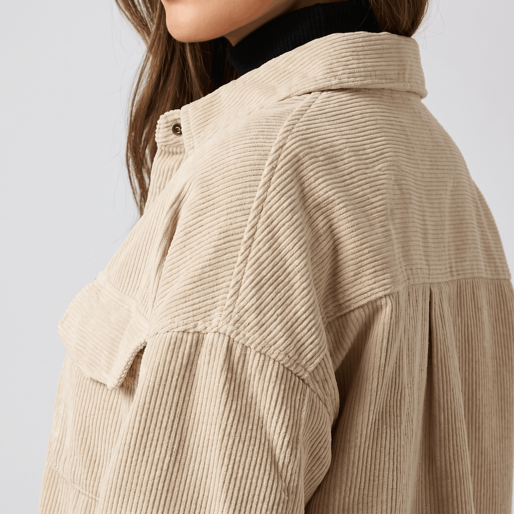Khaki wide wale corduroy shirt jacket with dropped shoulders, chest flap pockets, and an oversized fit.