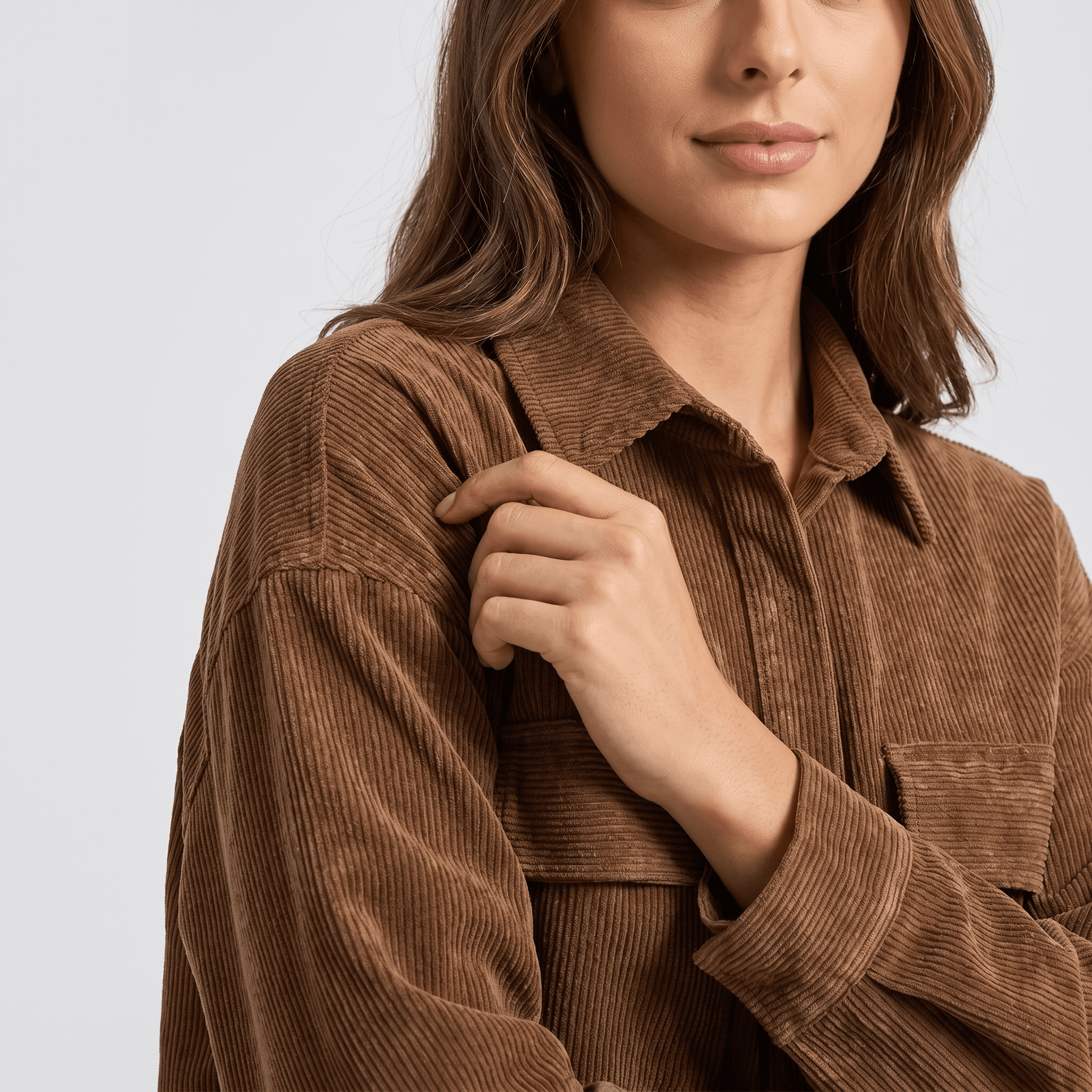 Khaki wide wale corduroy shirt jacket with an oversized fit, dropped shoulders, and buttoned chest flap pockets.