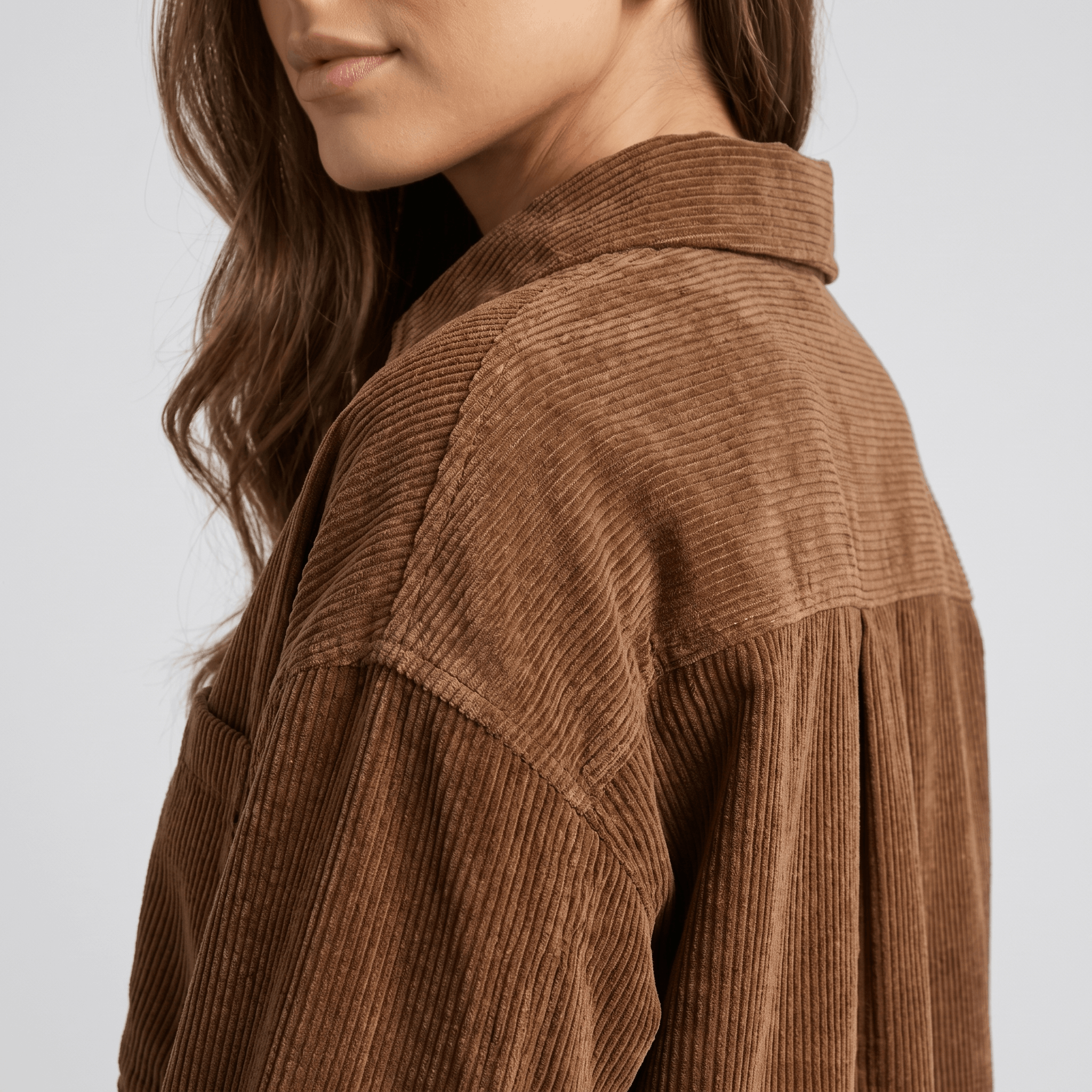 Khaki wide wale corduroy shirt jacket with a relaxed, oversized fit and dropped shoulders.