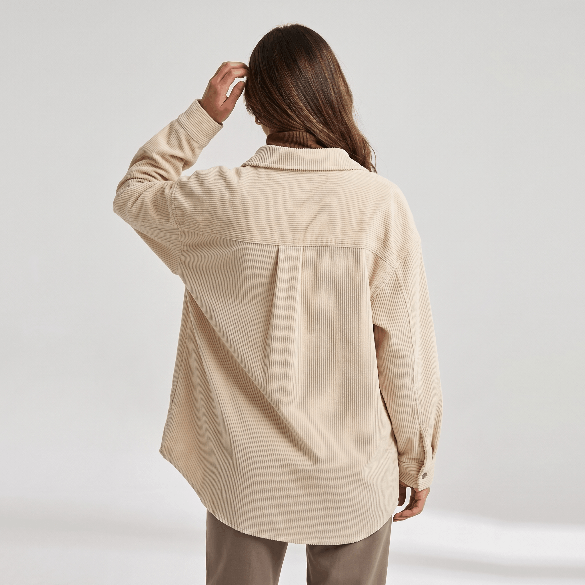 Khaki wide wale corduroy shirt jacket with an oversized fit, dropped shoulders, and a back yoke pleat.