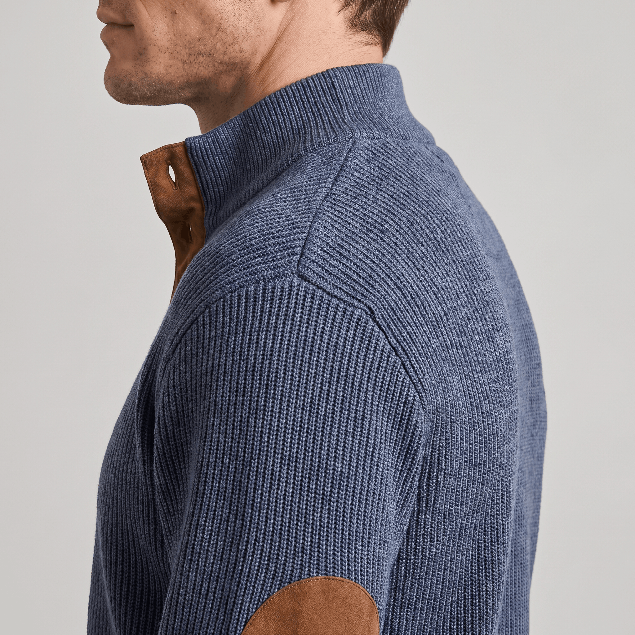 Blue vertical ribbed knit henley sweater with a snap stand collar and contrast brown elbow patches.