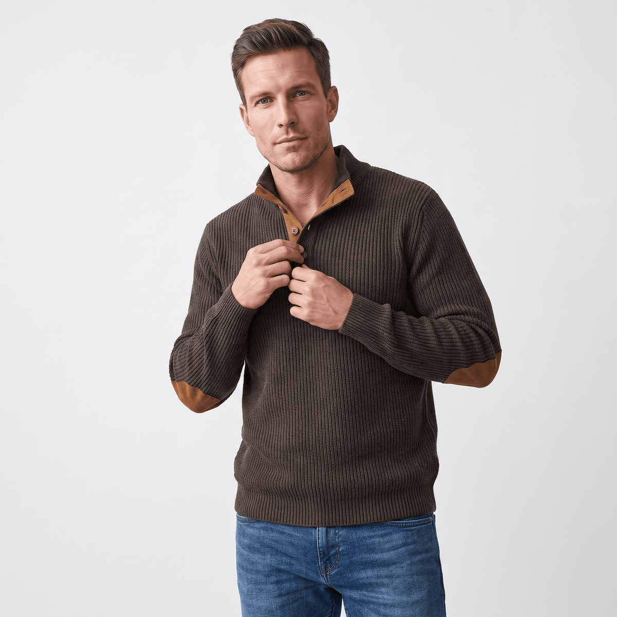 Dark brown ribbed knit henley sweater with a snap stand collar and contrast elbow patches worn over blue denim jeans.