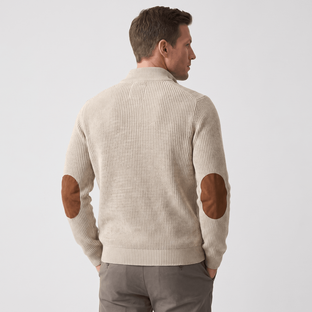 Beige vertical ribbed knit sweater with brown contrast elbow patches, stand collar, and relaxed fit.
