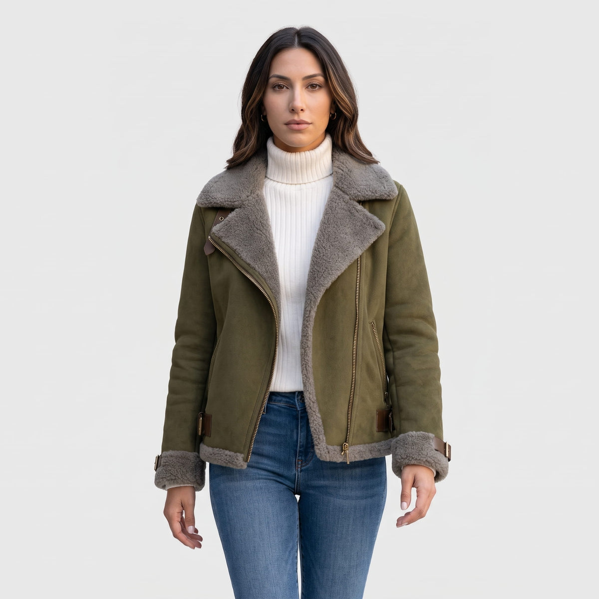 A woman wearing an olive green leather shearling aviator jacket with an asymmetric zip and buckled strap