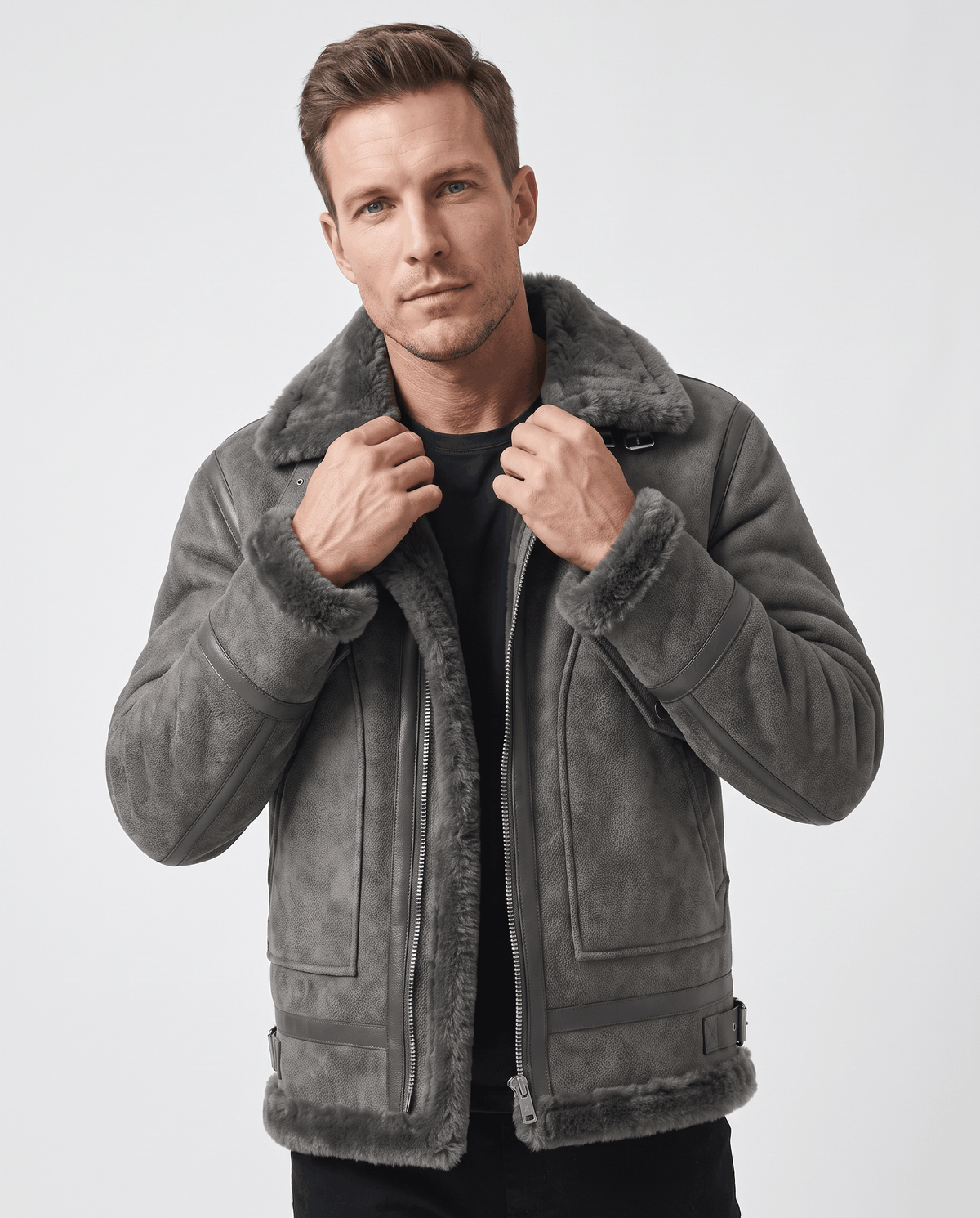 A man wearing a gray leather shearling aviator jacket with a distressed finish and lamb fur lining, front view