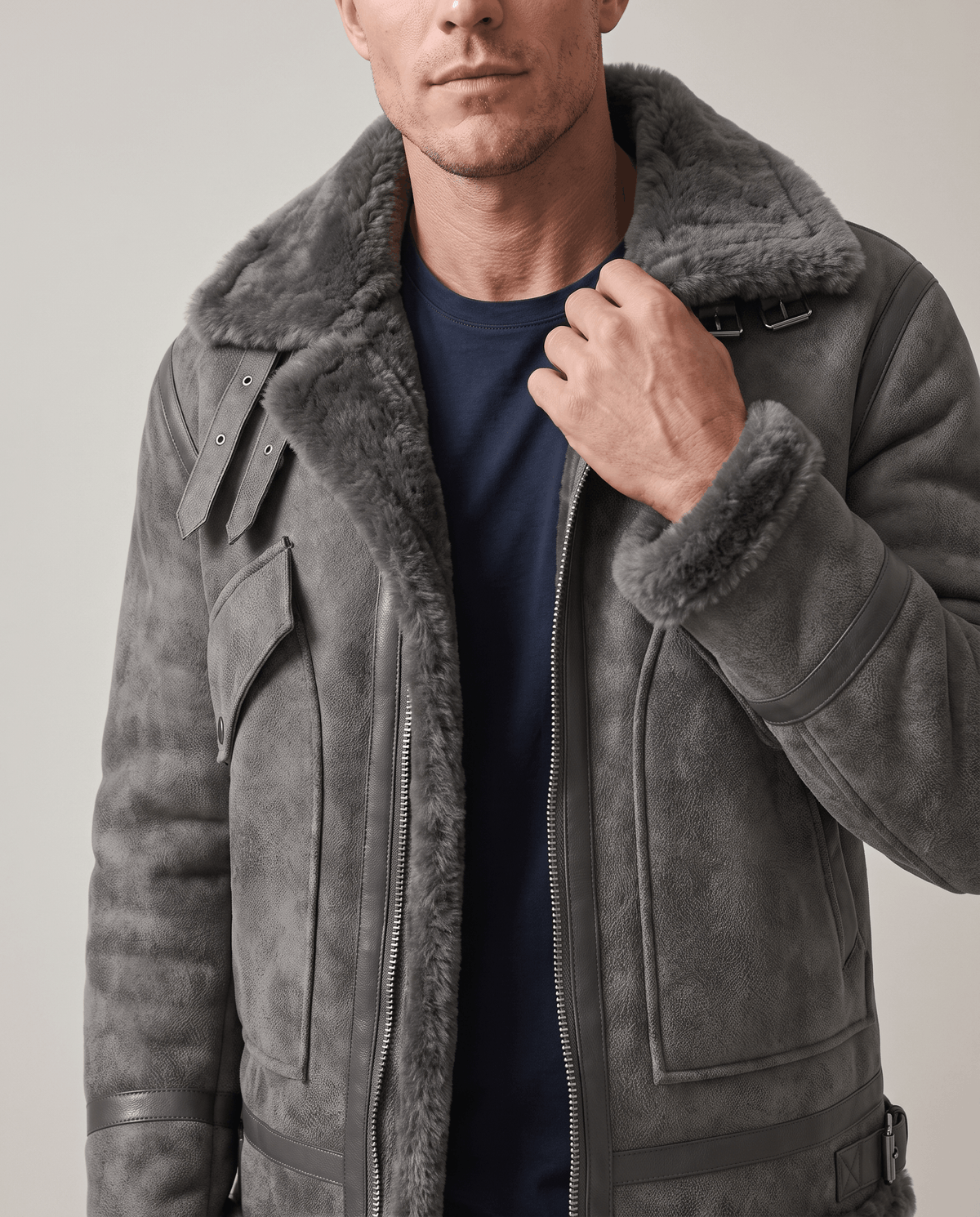 Close-up of a gray leather shearling aviator jacket showing the fur-lined collar and front closure