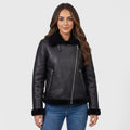A woman wearing a black leather shearling biker jacket with an asymmetrical zip and plush trim