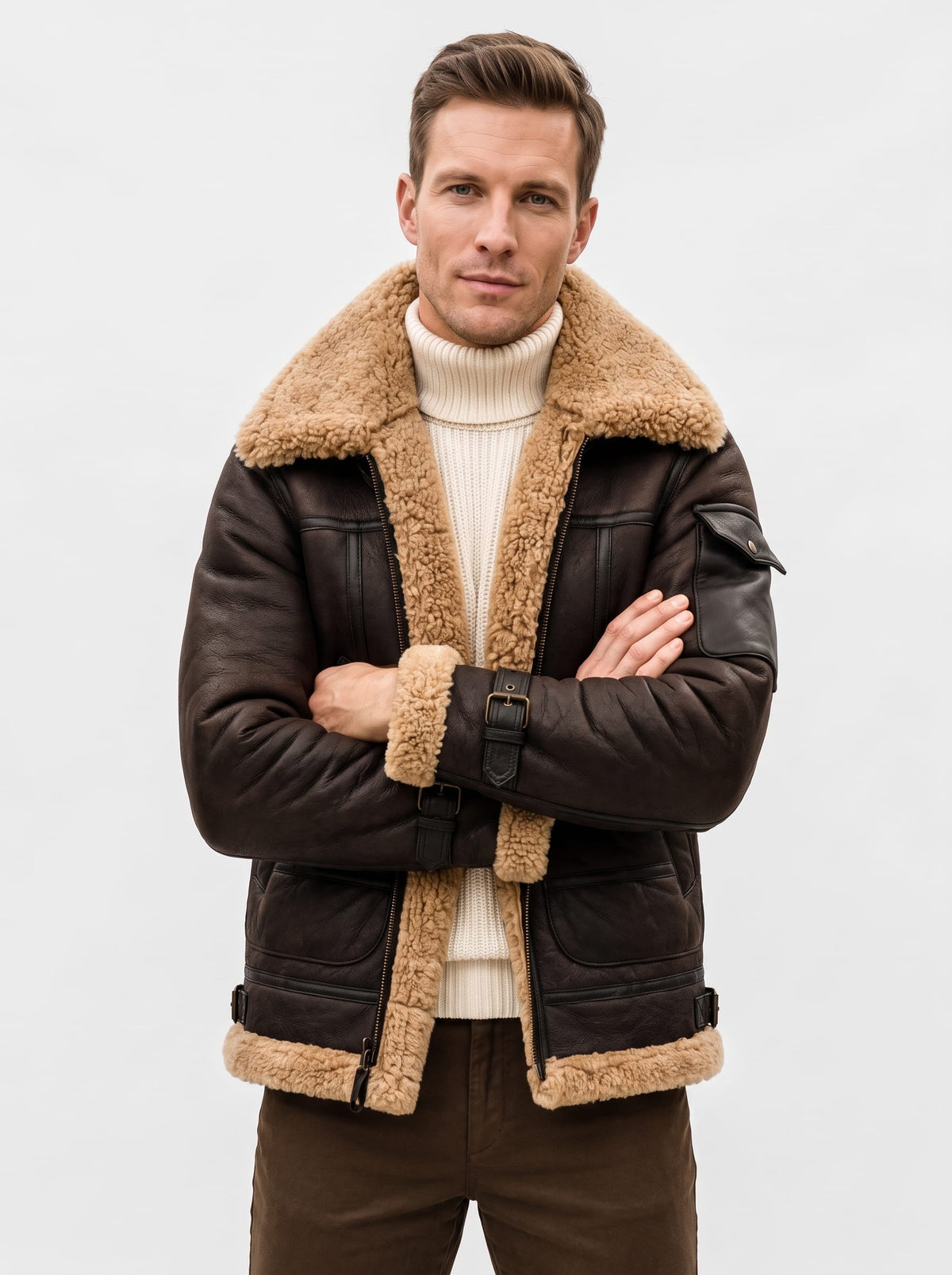 A man wearing a dark brown leather shearling bomber jacket with a sherpa collar and zip pockets, front view