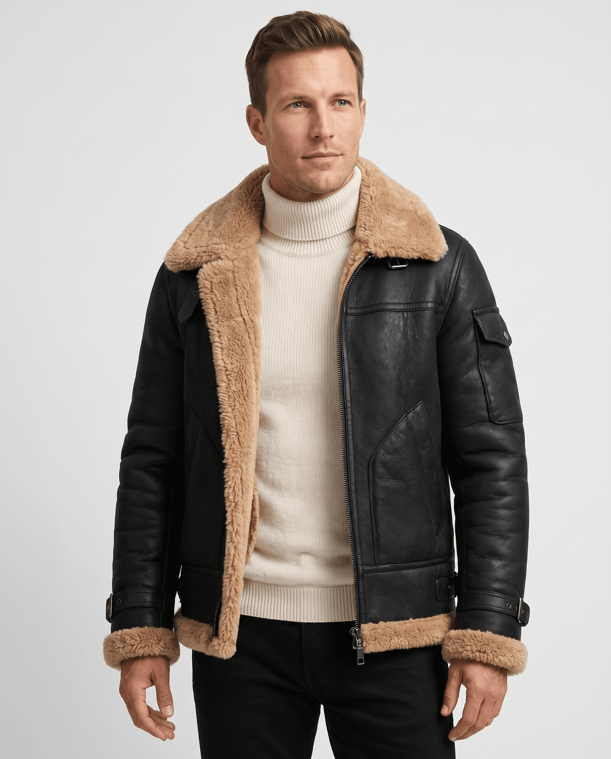A man wearing a black leather shearling jacket with fur lining and utility pockets, front view