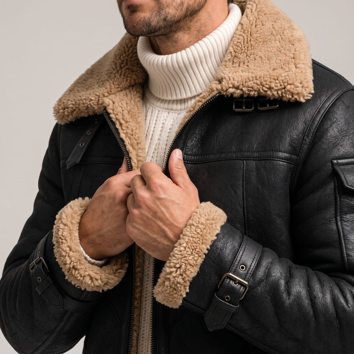 Close-up of a man wearing a black leather shearling jacket, showing the plush fur collar and front detail