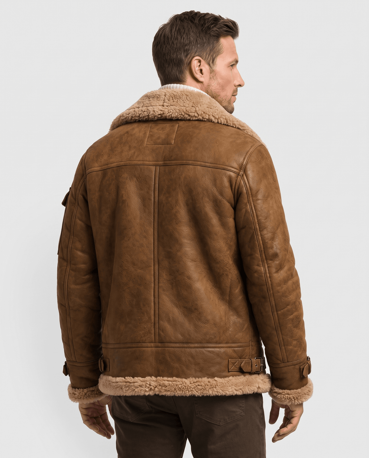 A man wearing a brown leather shearling jacket with fur lining, shown from the back